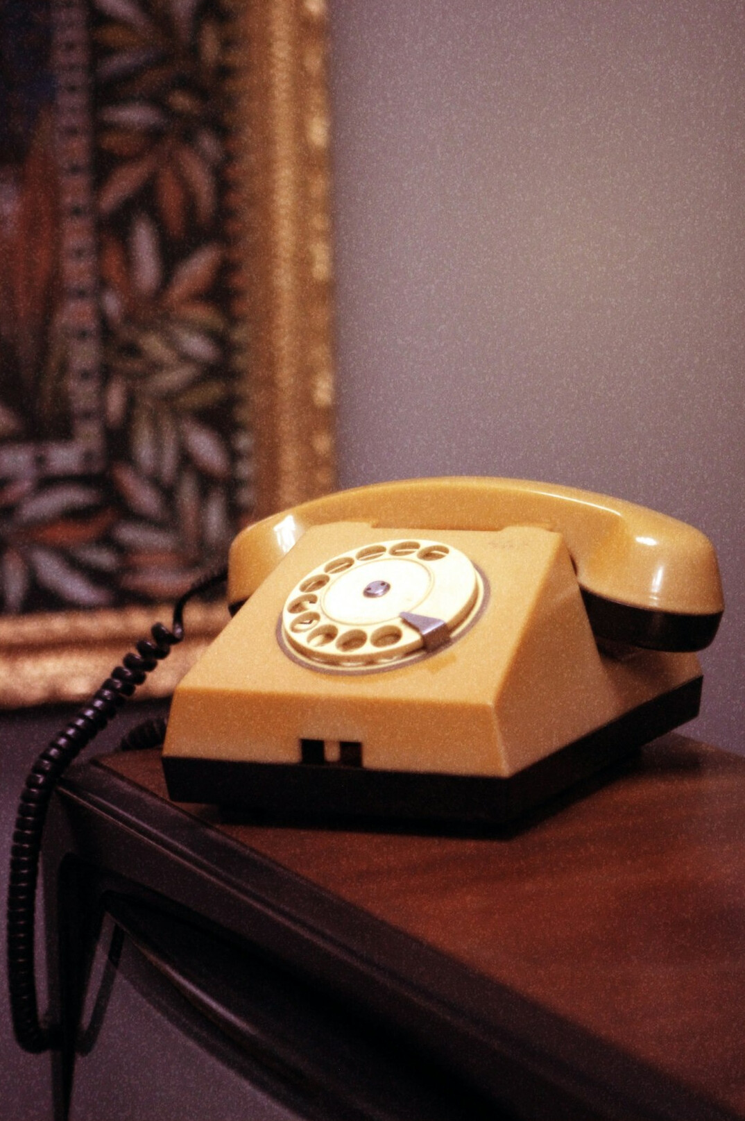 Editorial desk with notebooks, a rotary phone and old photographs