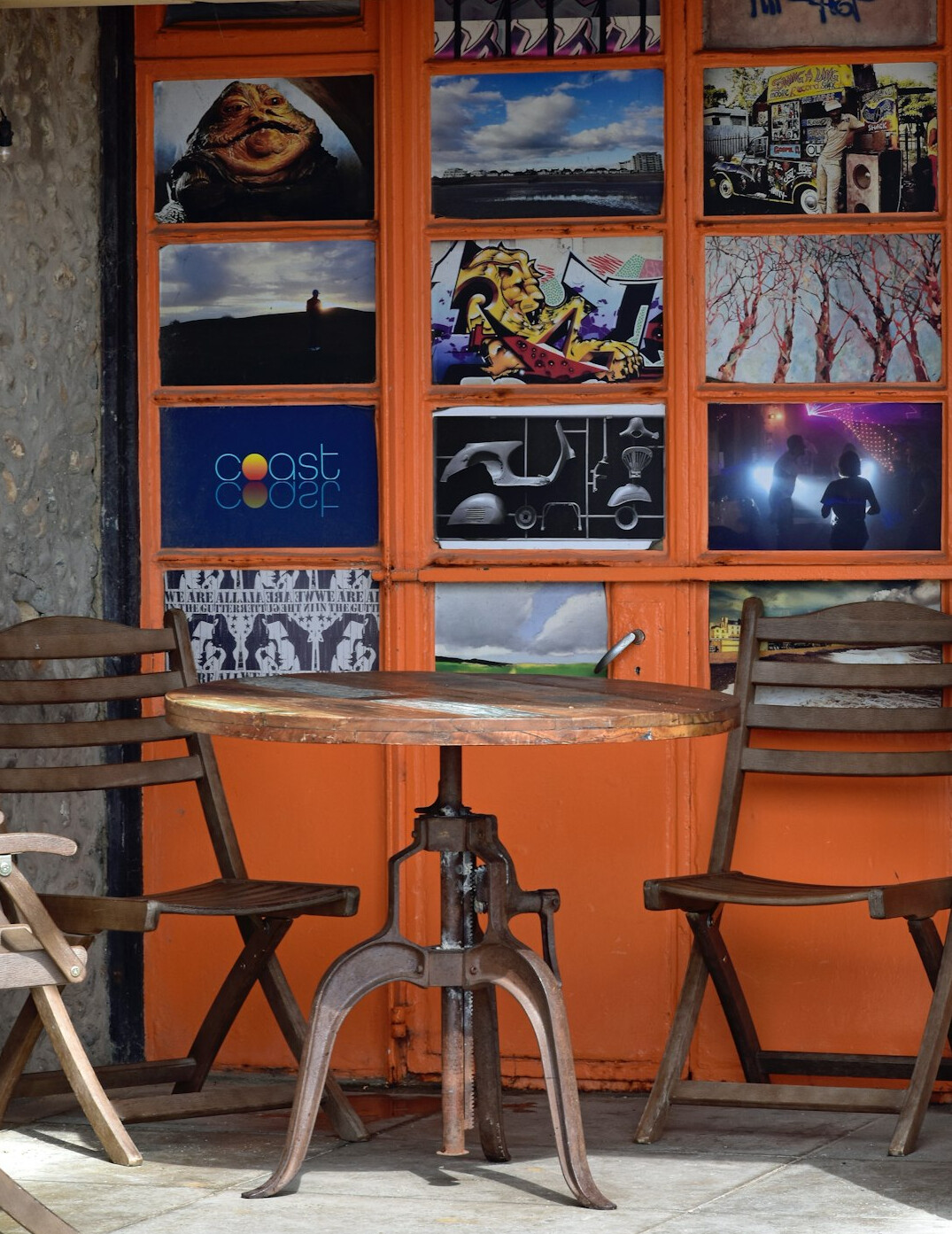 Archive of vintage advertising posters and film reels stacked on a wooden table